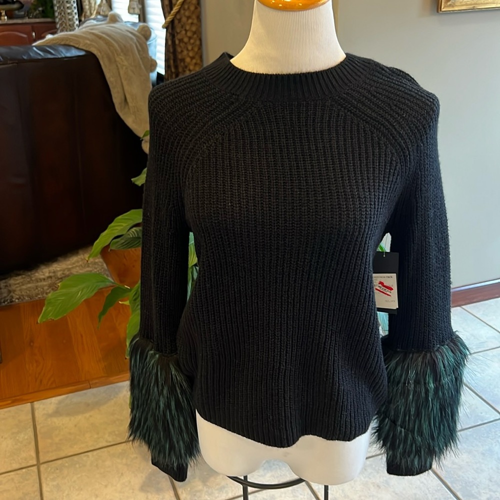 Small black sweater with green faux fur sleeves